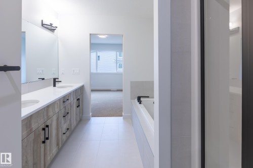 Double vanity with integrated sinks and wood-finish cabinetry - 4005 36 Street, Beaumont, AB 