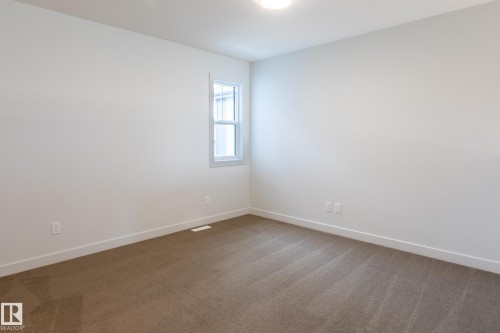 Neutral wall palette with a single window and recessed ceiling light - 4005 36 Street, Beaumont, AB 