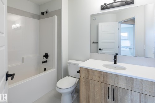 Built-in white bathtub with matte black fixtures - 4005 36 Street, Beaumont, AB 