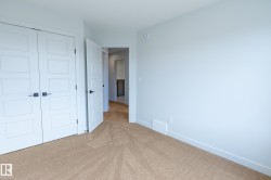 Wall-to-wall carpeting, modern paneled doors, and contemporary black hardware - 