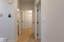 Light wood-finish flooring extending through the hallway - 4005 36 Street, Beaumont, AB 
