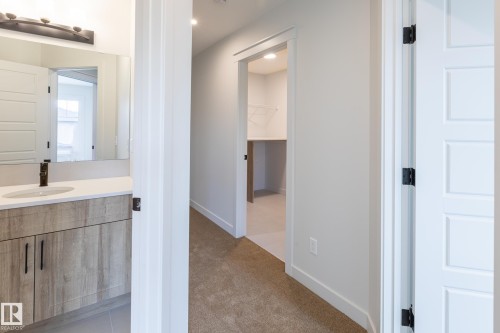 Modern vanity with a rectangular sink, light-toned countertop, and matte black faucet - 4005 36 Street, Beaumont, AB 