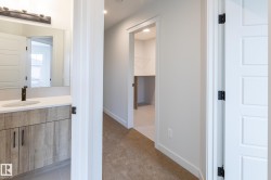 Modern vanity with a rectangular sink, light-toned countertop, and matte black faucet - 