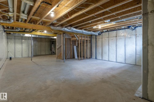 Unfinished basement with concrete flooring, exposed wood ceiling joists, and insulated perimeter walls - 4005 36 Street, Beaumont, AB 