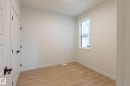 Light wood-finish flooring, white walls, and a double-hung window - 4005 36 Street, Beaumont, AB 