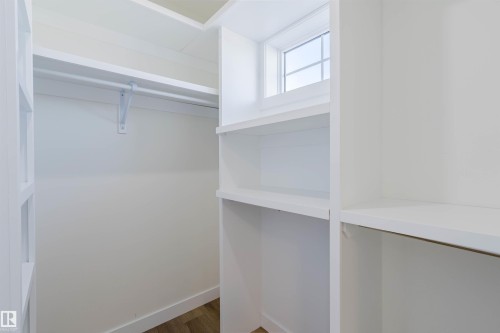Built-in shelving, white finish cabinetry, single window, wood-finish flooring, clothes hanging rod - 6047 180 Avenue Nw, Edmonton, AB 