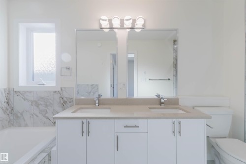 Dual sink vanity with white cabinetry and chrome hardware - 6047 180 Avenue Nw, Edmonton, AB 
