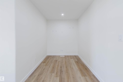 White painted walls, recessed ceiling lighting, wood-finish flooring, and white trim - 6047 180 Avenue Nw, Edmonton, AB 