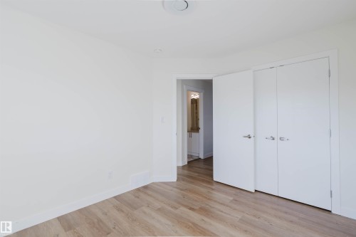 Wood-finish flooring with white walls and trim - 6047 180 Avenue Nw, Edmonton, AB 