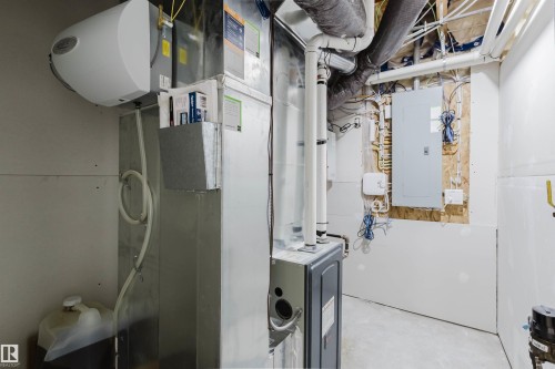 Furnace with exposed ductwork, water heater, and electrical panel - 6047 180 Avenue Nw, Edmonton, AB 