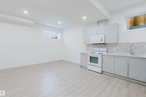 Kitchenette with light wood-finish flooring, white walls, and recessed lighting - 6047 180 Avenue Nw, Edmonton, AB 