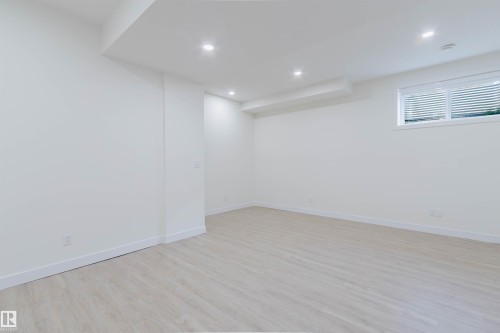 Recessed ceiling lighting, light wood-finish flooring, white walls, white trim, and a window with blinds - 6047 180 Avenue Nw, Edmonton, AB 