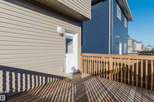 Wood-finish deck with a natural wood railing - 6047 180 Avenue Nw, Edmonton, AB 