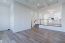 Wood-finish flooring throughout, recessed ceiling lighting, and a glass-paneled railing - 6047 180 Avenue Nw, Edmonton, AB 