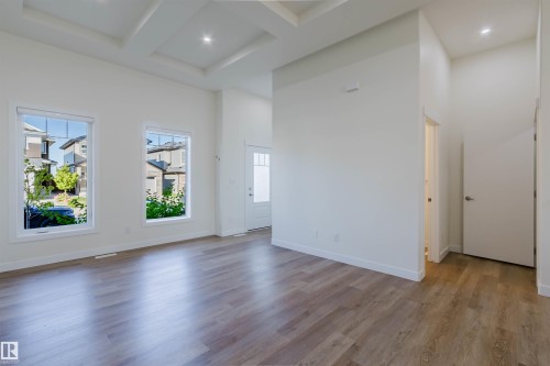 Tray ceiling with recessed lighting, wood-finish flooring, and white trim throughout - 6047 180 Avenue Nw, Edmonton, AB 