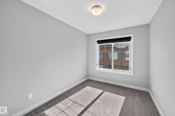 Neutral gray wall finish, white trim, flush mount ceiling light fixture, sliding window, and gray carpeting - 