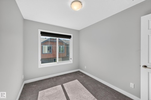 Neutral gray wall paint, white trim, and gray carpet - #44 3025 151 Av Nw, Edmonton, AB 