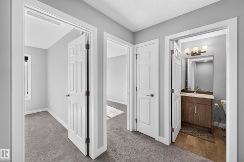 Light gray painted walls, paneled doors, and gray carpeted flooring - #44 3025 151 Av Nw, Edmonton, AB 
