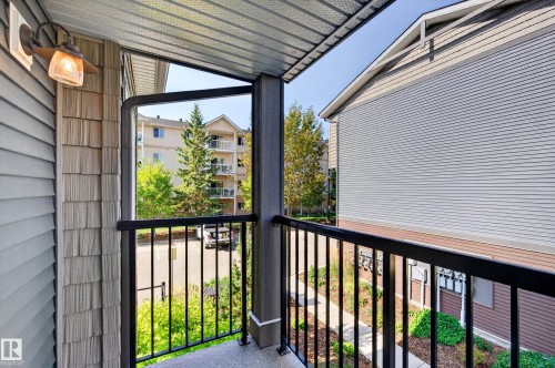 Private balcony featuring a black metal railing and textured exterior siding - #44 3025 151 Av Nw, Edmonton, AB 