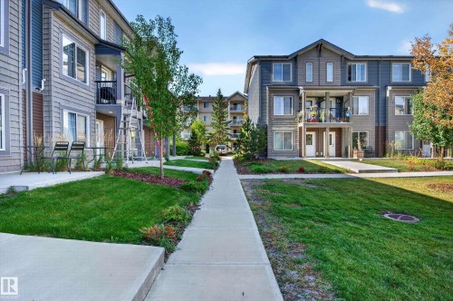 Townhome exteriors featuring horizontal siding and balanced landscaping - #44 3025 151 Av Nw, Edmonton, AB 