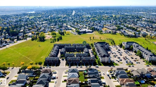 Aerial perspective showcasing a residential community with abundant green spaces - #44 3025 151 Av Nw, Edmonton, AB 