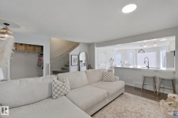 Open concept living space with wood-finish flooring - 