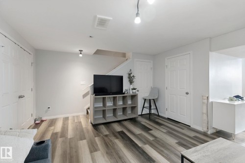 Wood-finish flooring throughout, bright white walls, and a recessed ceiling light - 8535 Ellis Link Link Nw, Edmonton, AB 