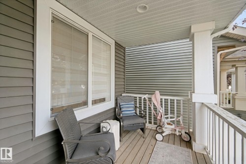 Front porch with durable siding, white trim, and a wood-finish floor - 8535 Ellis Link Link Nw, Edmonton, AB 