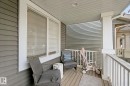Front porch with durable siding, white trim, and a wood-finish floor - 8535 Ellis Link Link Nw, Edmonton, AB 