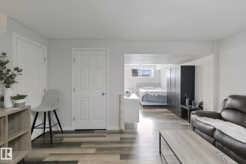 Wood-finish flooring throughout, white walls, and white paneled doors - 8535 Ellis Link Link Nw, Edmonton, AB 