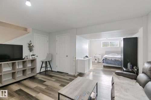 Wood-finish flooring throughout, white interior doors, and recessed lighting - 8535 Ellis Link Link Nw, Edmonton, AB 