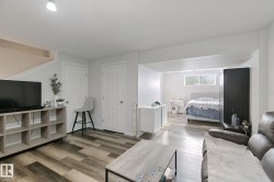 Wood-finish flooring throughout, white interior doors, and recessed lighting - 