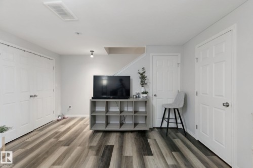 Multitone wood-finish flooring, white paneled doors, and recessed ceiling lighting - 8535 Ellis Link Link Nw, Edmonton, AB 