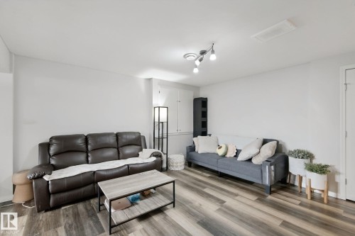 Wood-finish flooring, recessed lighting, and built-in storage cabinetry - 8535 Ellis Link Link Nw, Edmonton, AB 