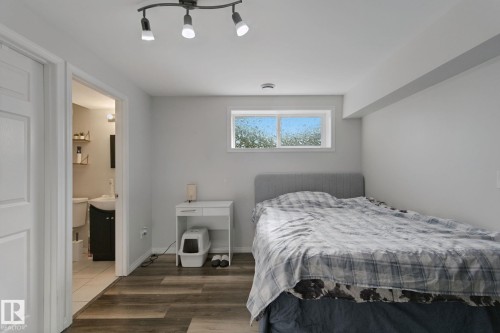Wood-finish flooring, white walls, and a window providing natural light - 8535 Ellis Link Link Nw, Edmonton, AB 