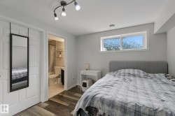 Wood-finish flooring, white paneled doors, and a window with privacy glass - 