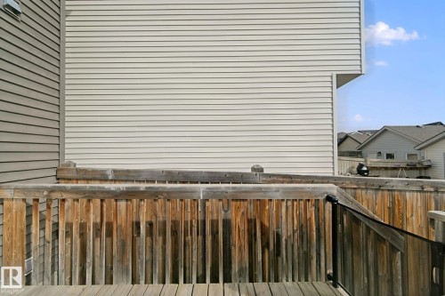 Wooden deck with a matching wooden railing - 8535 Ellis Link Link Nw, Edmonton, AB 