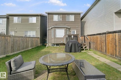 Enclosed backyard with a partial wooden fence and grass lawn - 8535 Ellis Link Link Nw, Edmonton, AB 