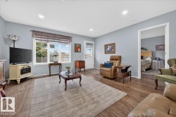 Hardwood-finish flooring throughout, recessed ceiling lighting, and a white-framed window - 