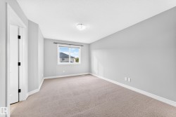 Carpeted flooring with a white trim, light gray painted walls, and a white ceiling light fixture - 