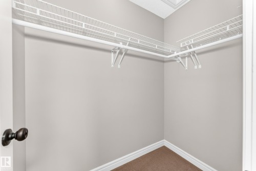 Corner closet featuring wire shelving and a hanging rod - Edmonton, AB 