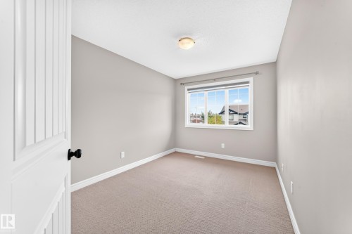 Neutral-toned wall paint, white trim, and light-colored carpet flooring - Edmonton, AB 