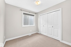 Neutral-toned walls complement the light-colored carpet flooring - 