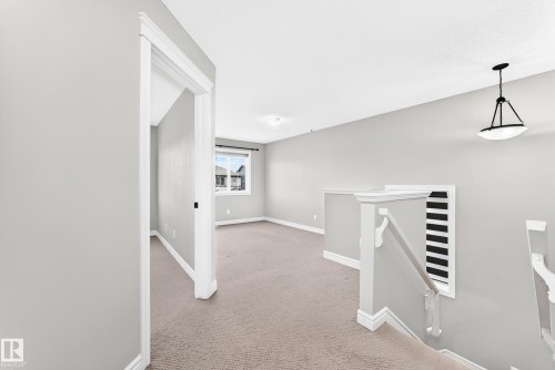 Carpeted flooring, white trim, and light gray walls define this interior space - Edmonton, AB 