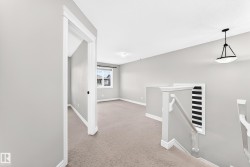 Carpeted flooring, white trim, and light gray walls define this interior space - 