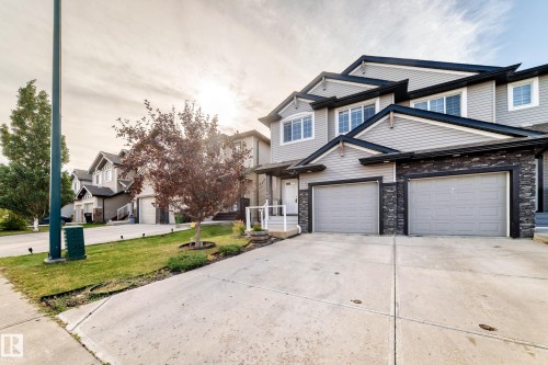 Grey horizontal siding and dark stone facade - Edmonton, AB 