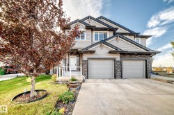 Contemporary exterior with mixed material siding and stone accents - 