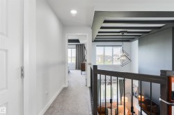 Carpeted hallway with recessed lighting - 