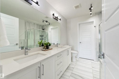 Dual vanity with white cabinetry and quartz countertops - 1032 Berg Place, Leduc, AB 