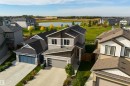 Contemporary multi-level residence with an attached garage, featuring a concrete driveway and landscaped front yard - 1032 Berg Place, Leduc, AB 